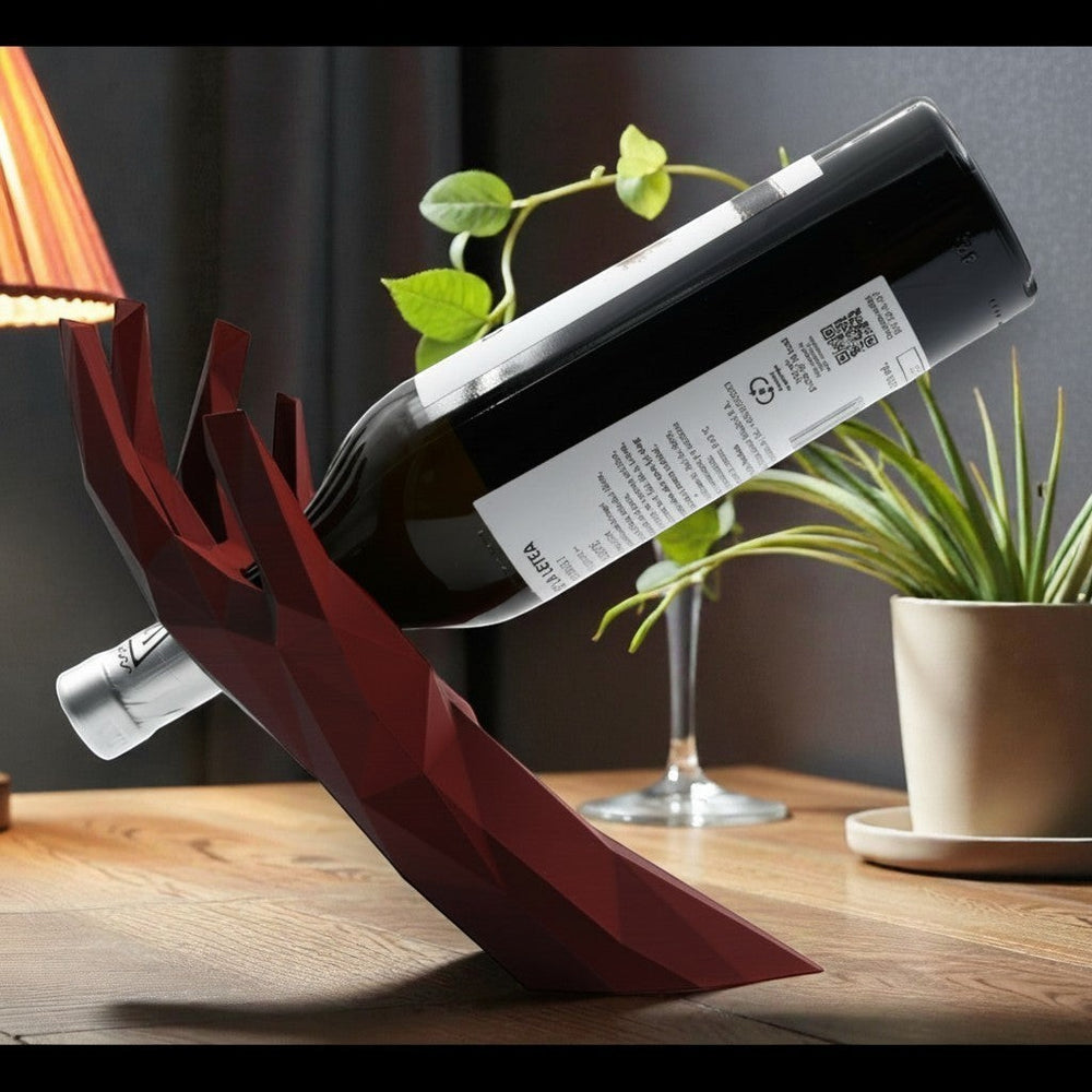 Tom GO modern geometric wine bottle holder in deep red acrylic, shaped like a hand cradling a bottle.