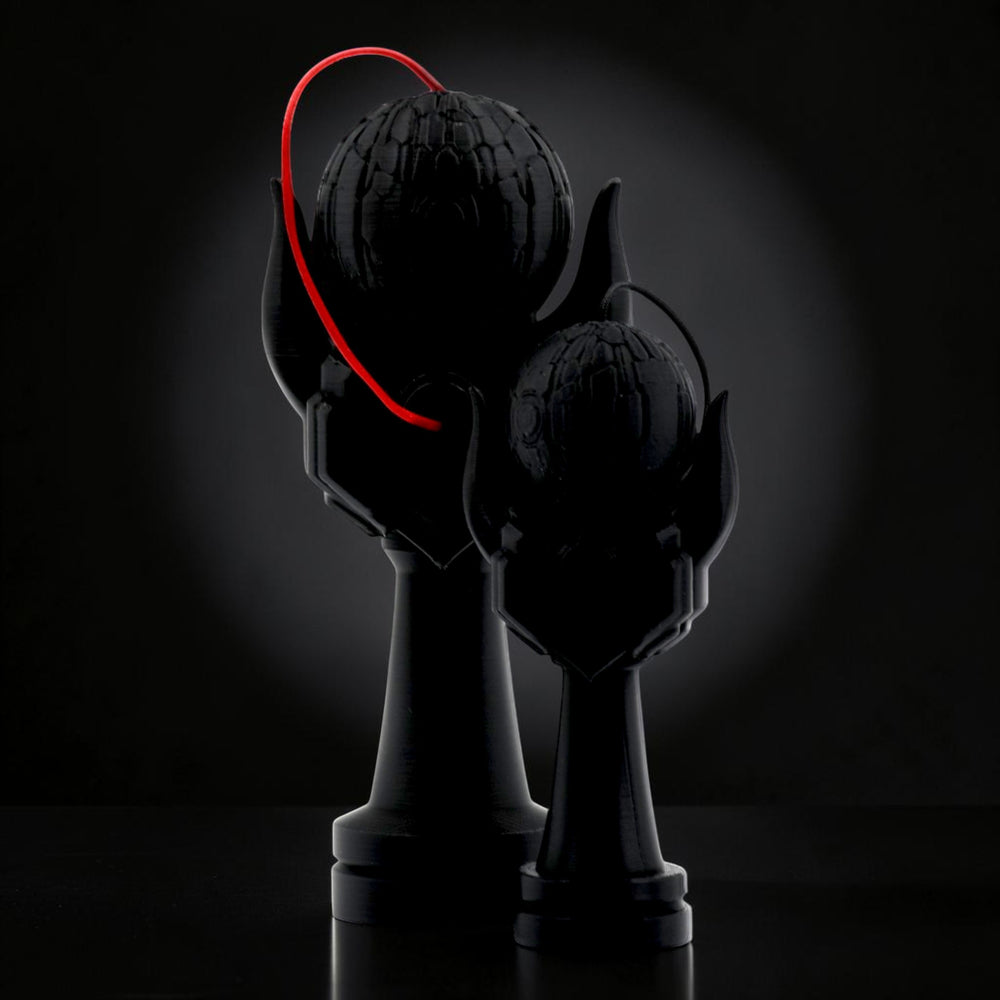 Tom GO Kendama Geeker Iron M black kendama with red string, featuring a textured tama and a unique handle design.
