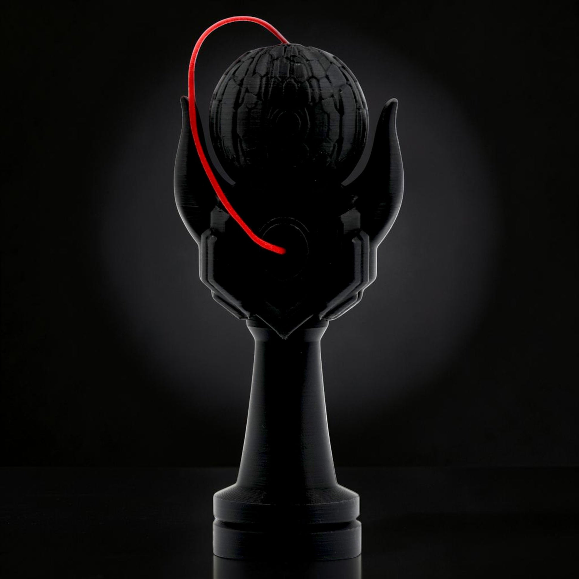 Tom Go Kendama Geeker Iron M, black, with red string, featuring a textured tama and unique handle design.