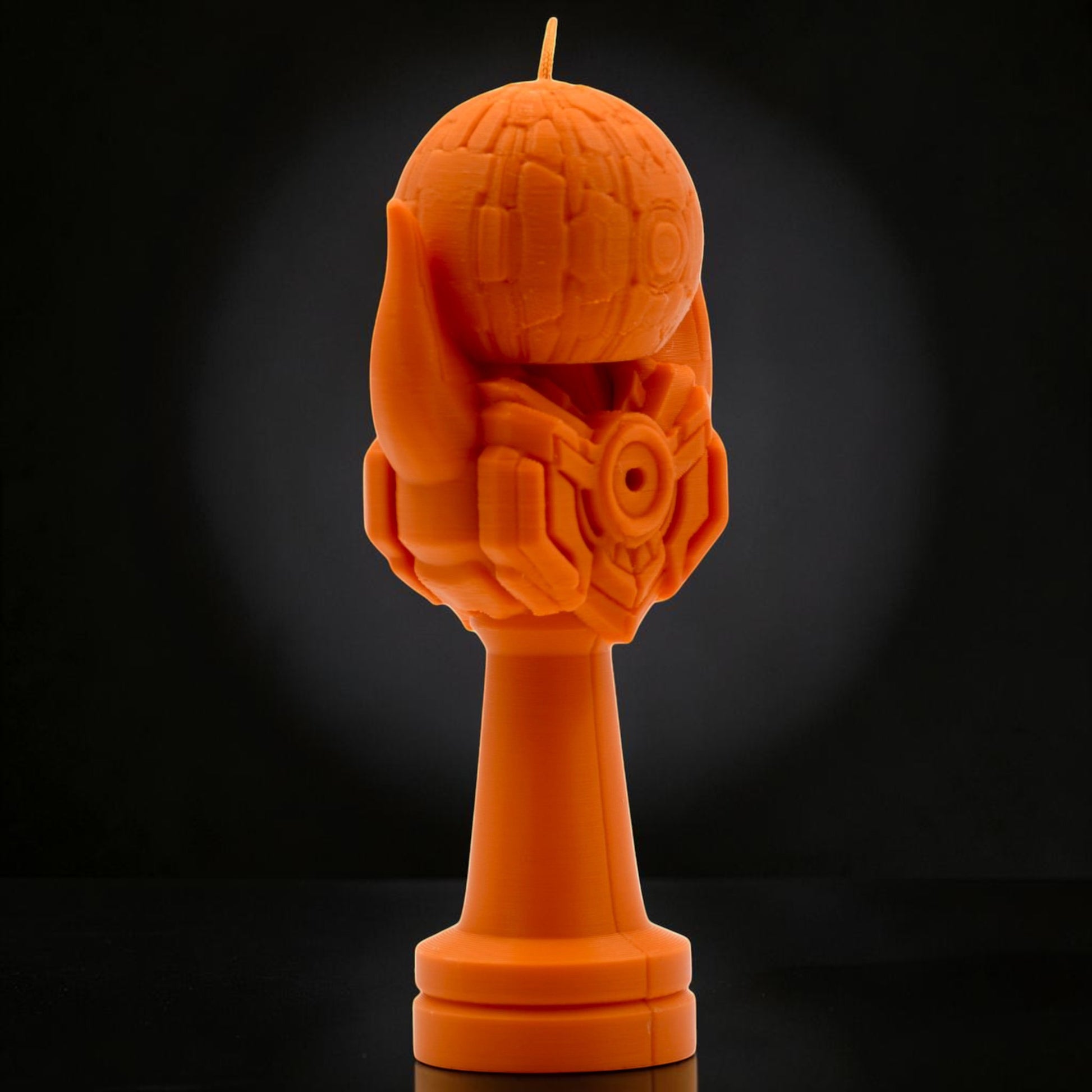 Tom Go Kendama Geeker Iron M orange candle with intricate mechanical details and a base.
