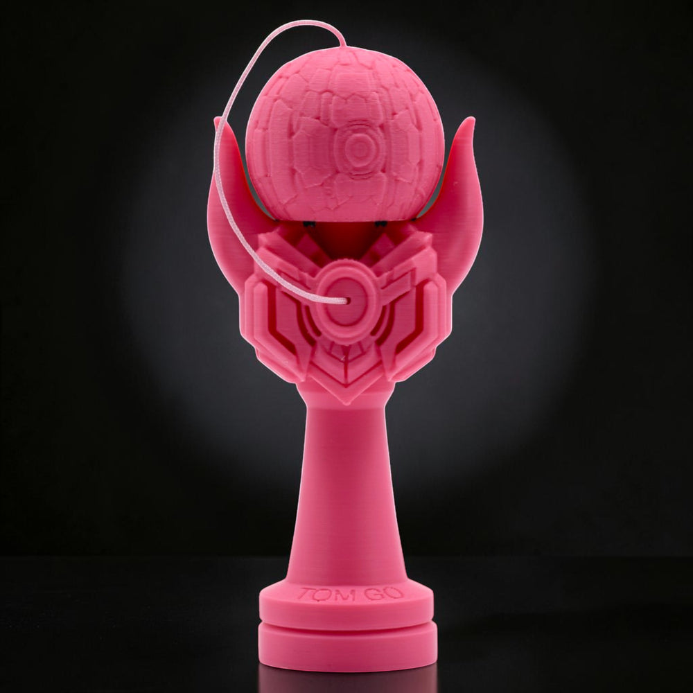 Tom GO Kendama Geeker Iron M, a bright pink 3D printed kendama with a unique, armored design and intricate details on the tama and ken.