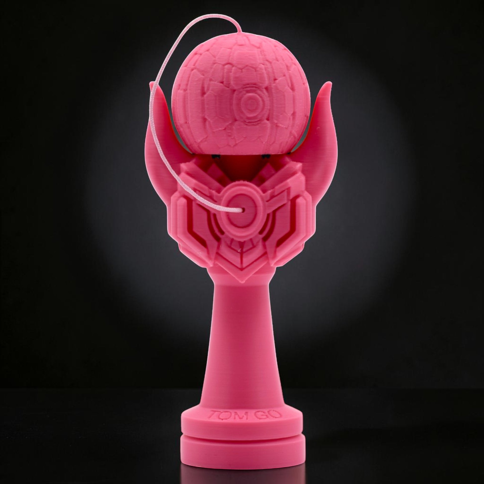 Tom GO Kendama Geeker Iron M, a bright pink 3D printed kendama with a unique, armored design and intricate details on the tama and ken.