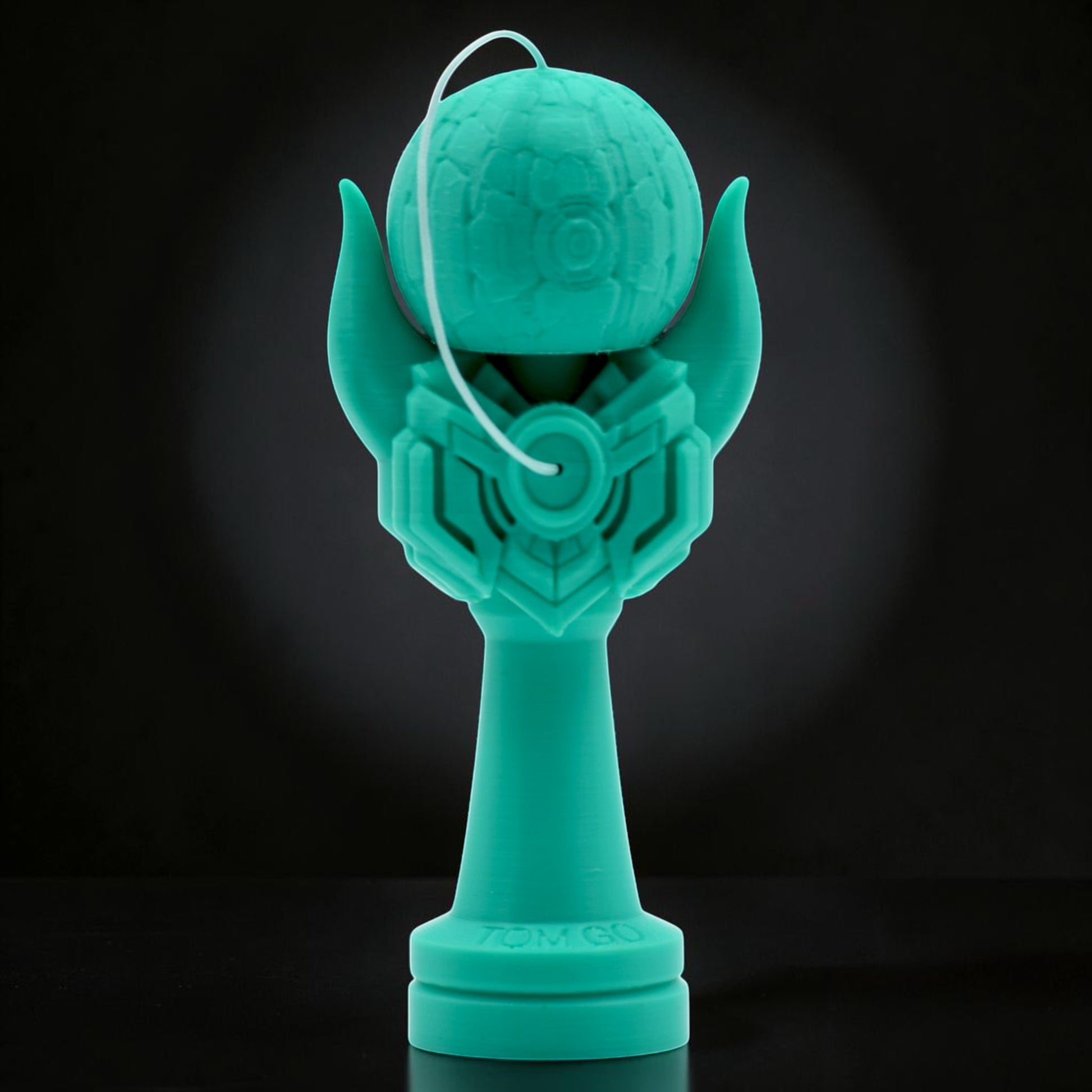 Teal Kendama Geeker Iron M with intricate design, featuring a textured tama and a stylized handle. Tom GO.