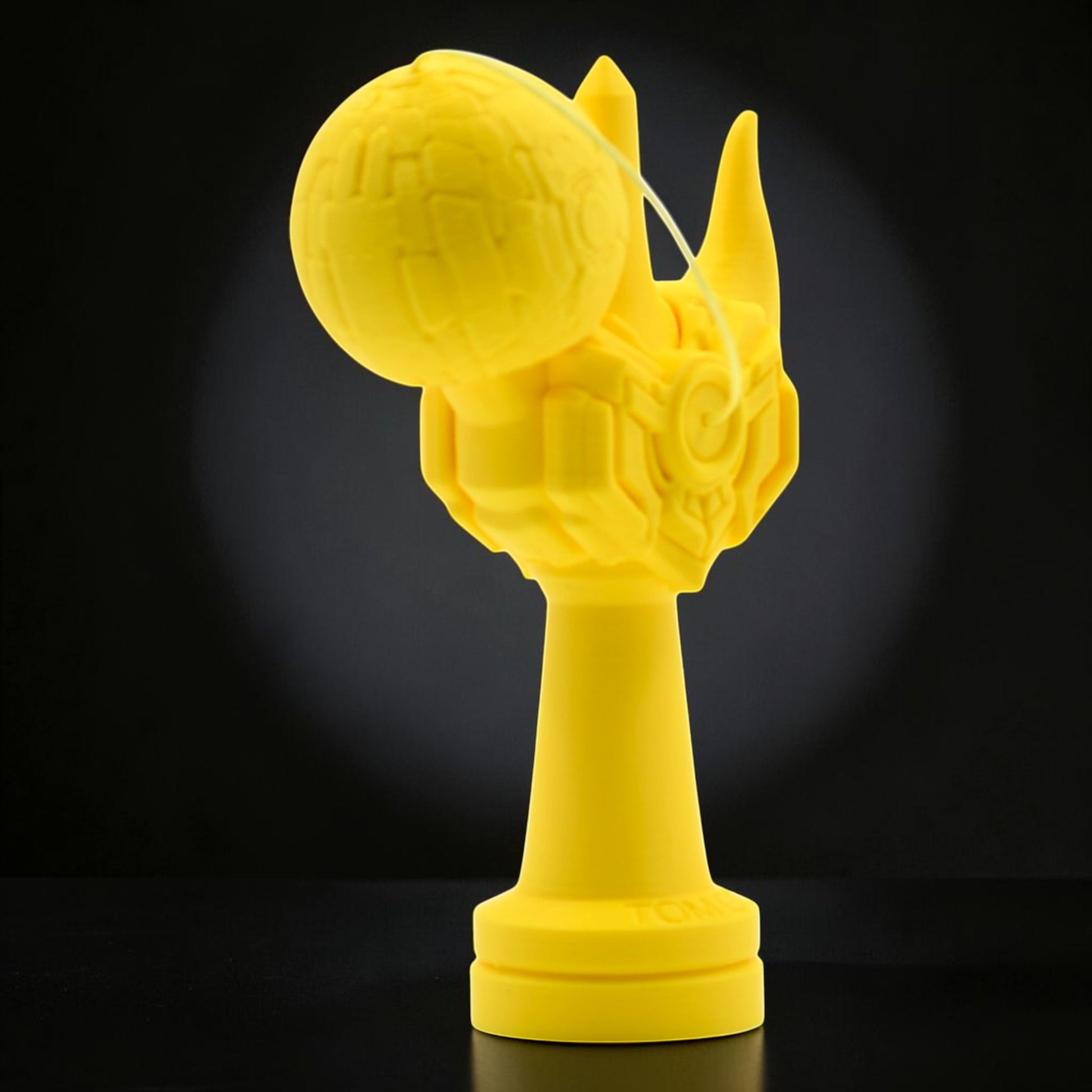 Tom GO Kendama Geeker Iron M, a bright yellow kendama with a unique, robotic-inspired design, featuring intricate detailing on the cup and a textured tama.