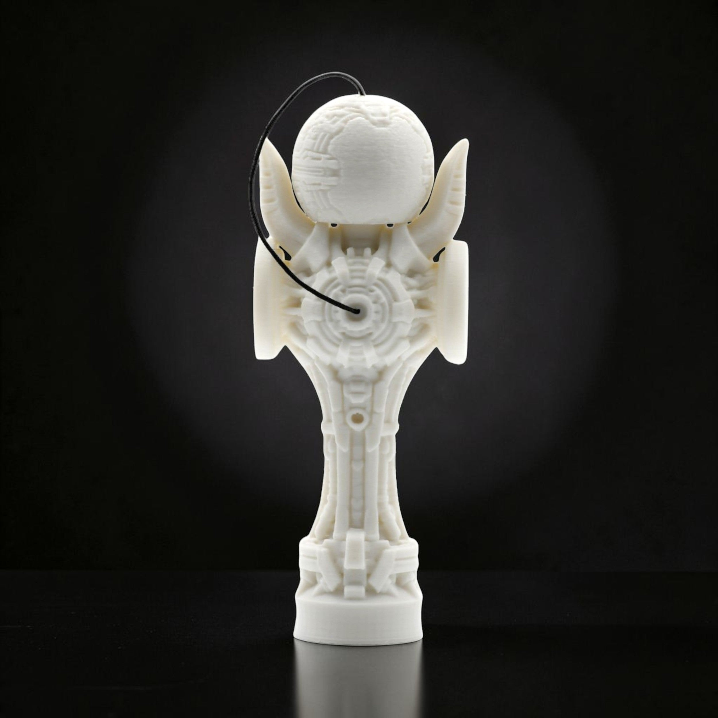 Tom GO Kendama Geeker TOM Angel, a white, intricately designed skill toy with a futuristic, geometric aesthetic and a black string.