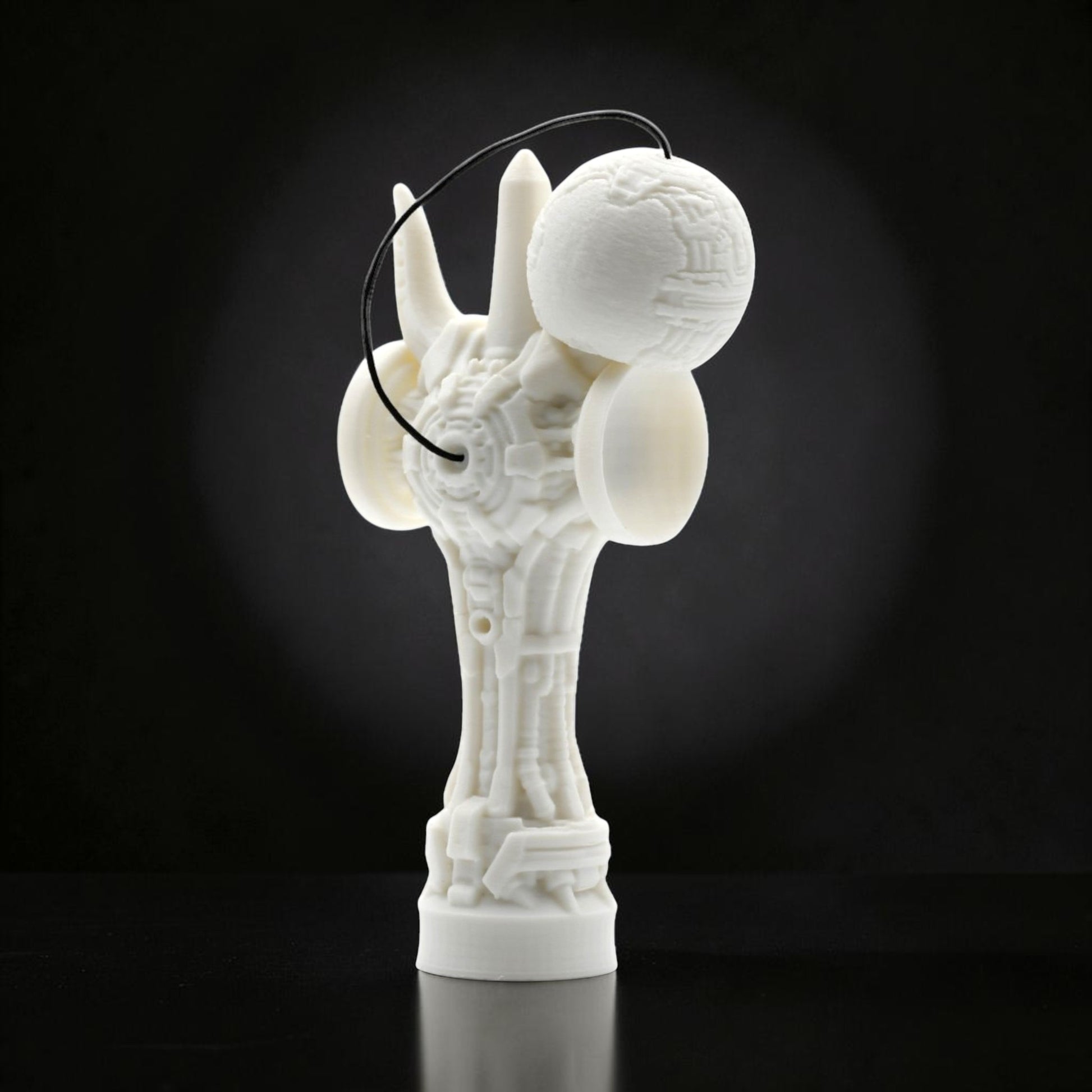 Tom GO Kendama Geeker TOM Angel, a white, intricately designed skill toy with a futuristic, geometric aesthetic and a black string.