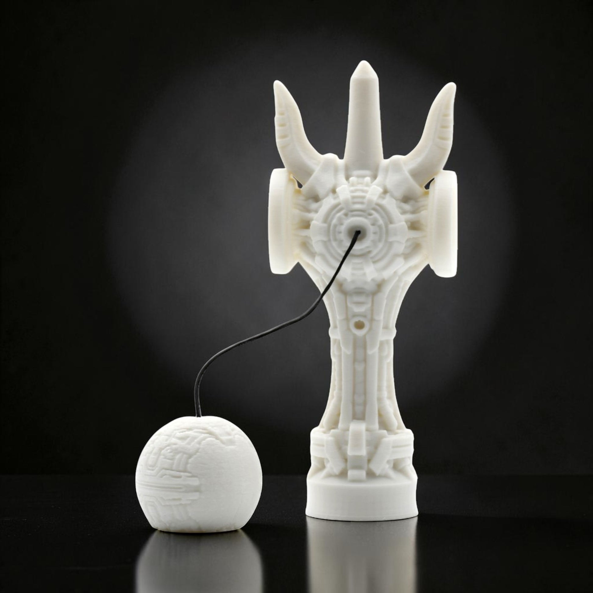 Tom GO white futuristic kendama with intricate geometric design and a spherical tama.