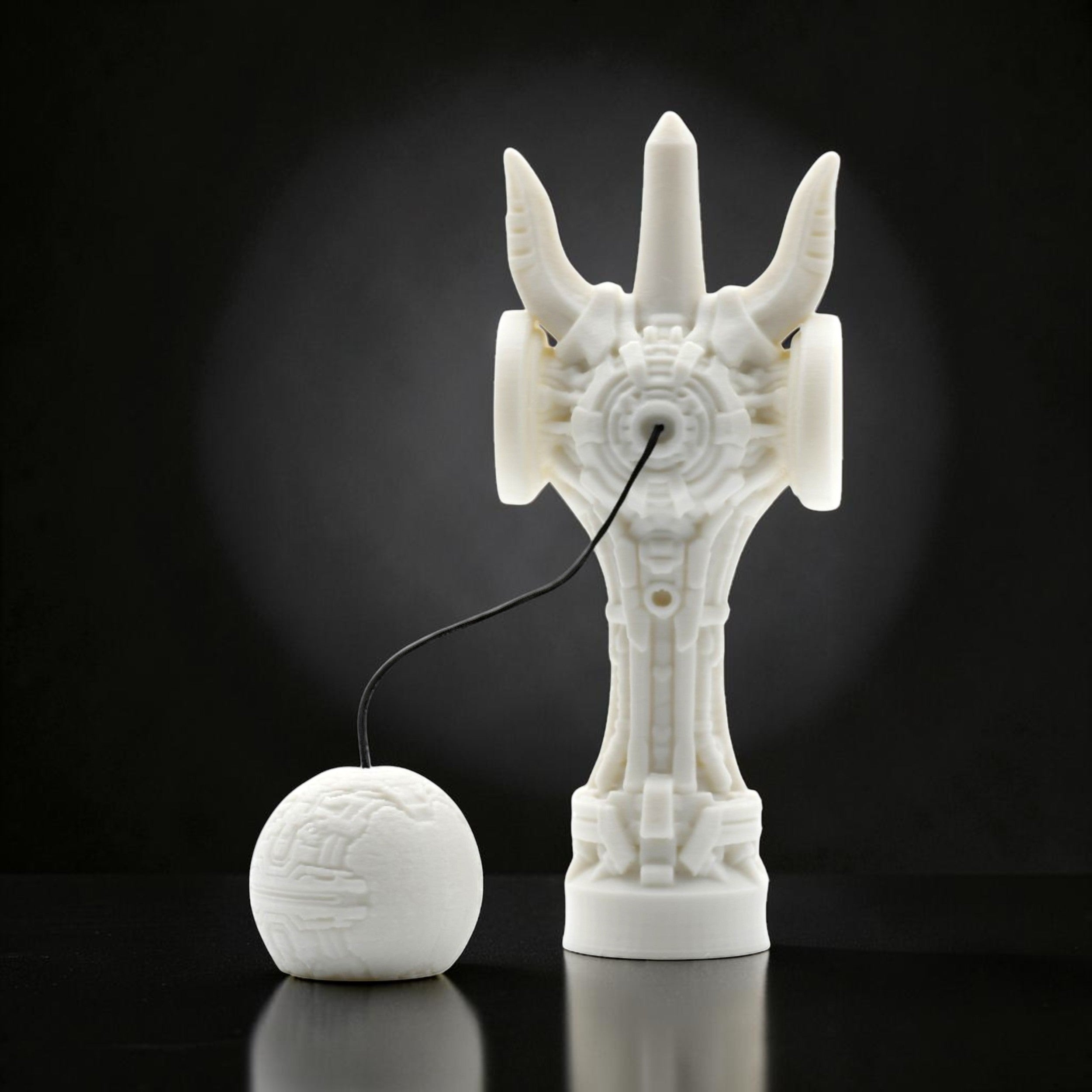 Tom GO white futuristic kendama with intricate geometric design and a spherical tama.