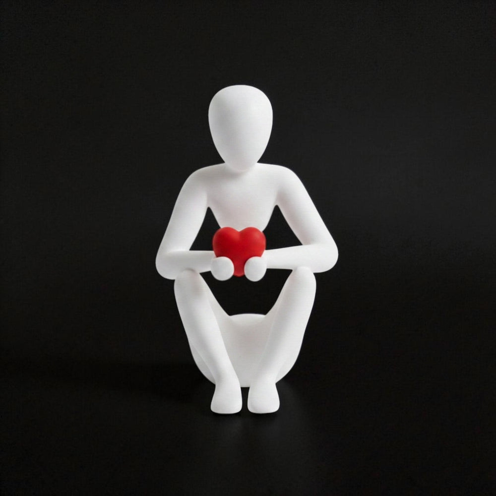 Tom GOH abstract white figurine holding a red heart, minimalist design, matte finish.
