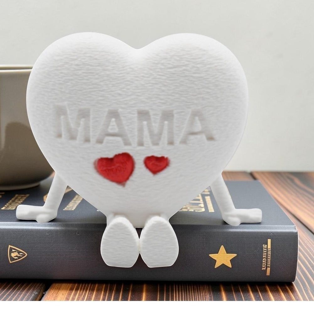 Tom Goh white textured heart figurine with "MAMA" embossed and two red hearts, featuring articulated legs.