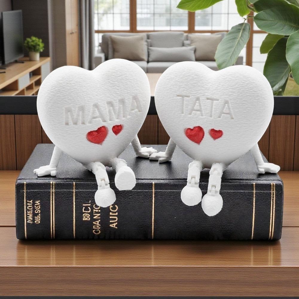 Tom Goh white textured heart figurine with articulated legs, embossed with MAMA and two red hearts.